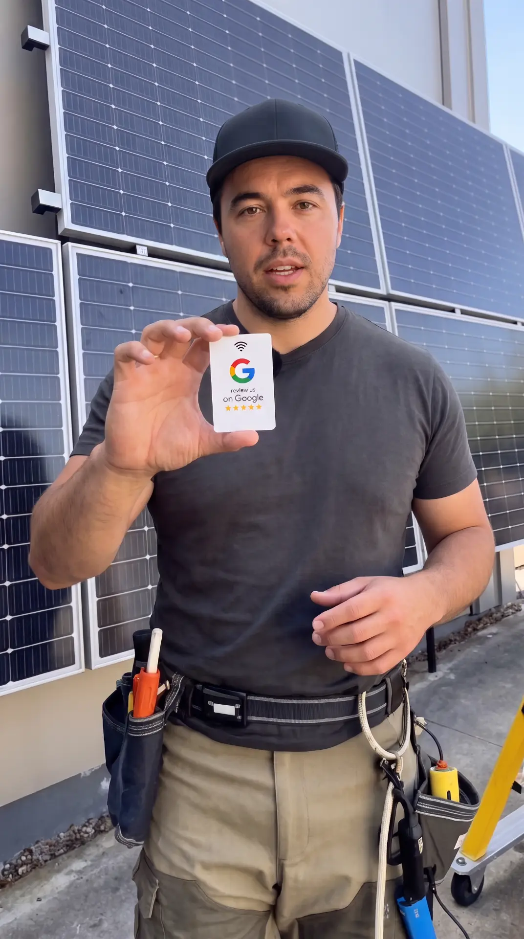 Tradesman holding an NFC Google review card