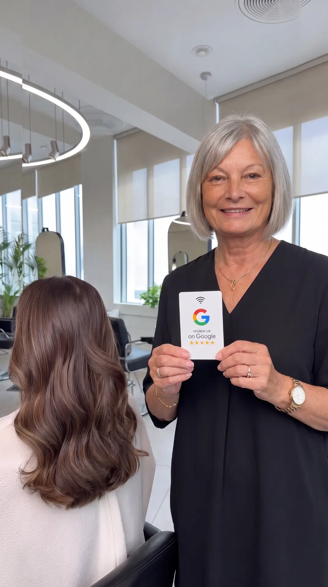 Hair salon owner holding an NFC Google review card