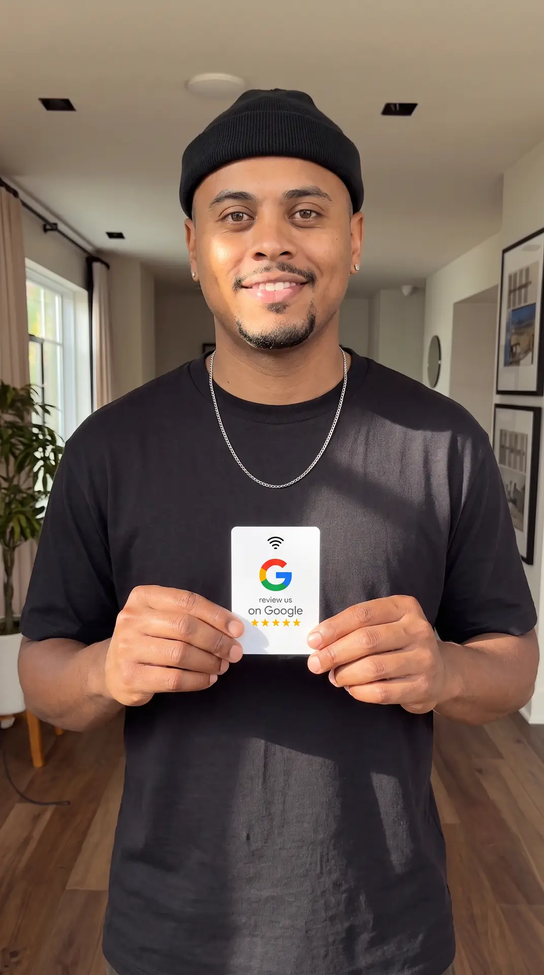 Shop owner showing a white NFC Google review card